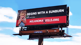 A long shot of the Melanoma Kills bill boards